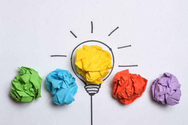 istock Creative thinking ideas and innovation concept. Paper scrap ball yellow colour with light bulb symbol 1485394672