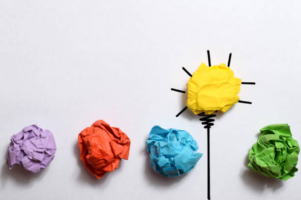 istock Creative thinking ideas and innovation concept. Paper scrap ball yellow colour with light bulb symbol 1485394707