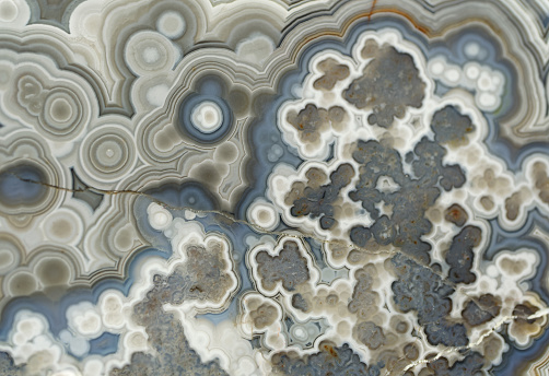 Agate, beautiful decorative stone, abstract blue, gray and white pattern, natural background