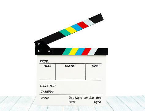 Film slate or Flying clapperboard on wooden table isolated on white background, Save clipping path.