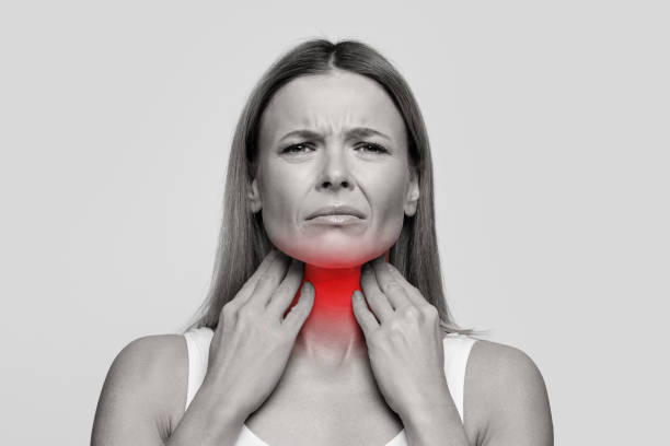istock Woman suffering from sore throat, touching her neck 1485400101