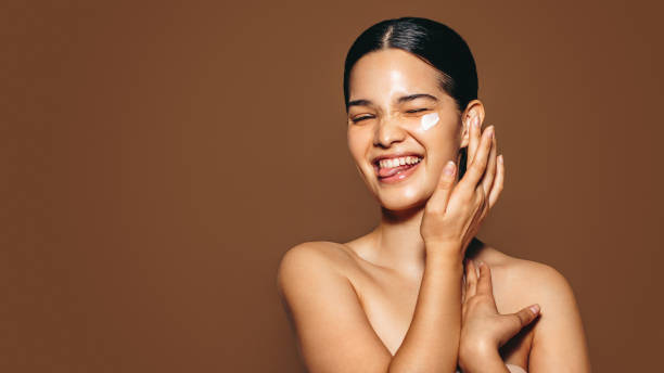 istock Having fun taking care of my face using cosmetic beauty cream 1485400602