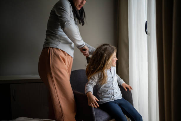 istock Mother brushing little daughter's hair 1485402899