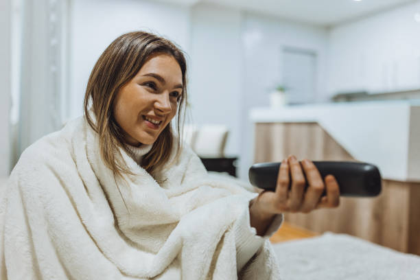 istock A sick woman feeling better and watching TV 1485408490