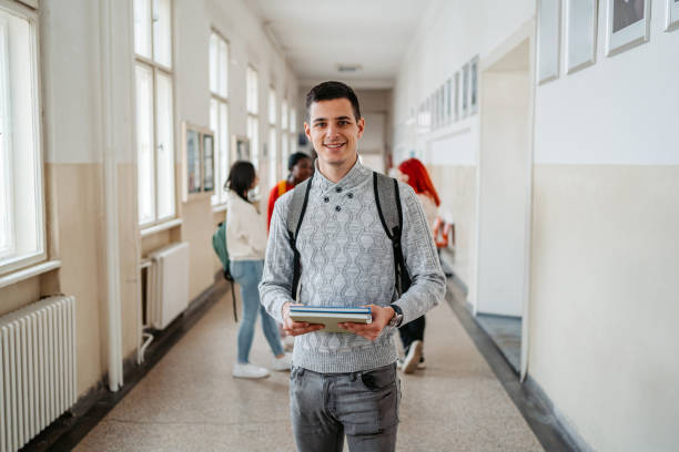 istock Young Male Student Standing In The Hall In University 1485408509