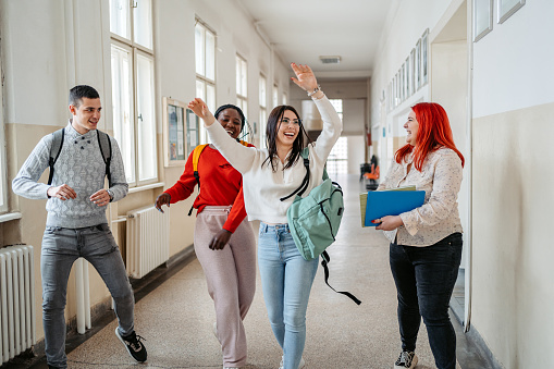 Students dancing down the hall in College.