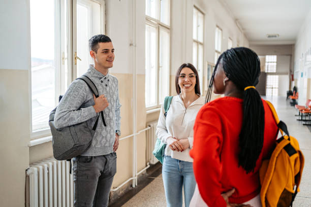 istock Students Talking In The Hall In University 1485410956