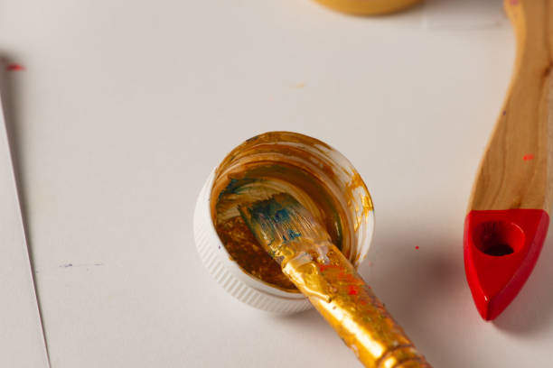 istock Artist's workplace, brush in gold paint 1485411251
