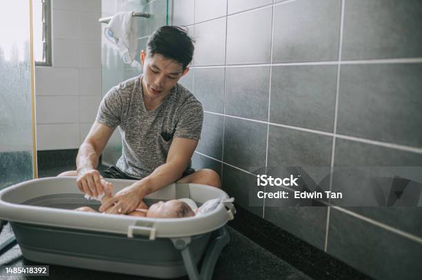 Asian Chinese Father Bathing Baby Boy In Bathroom Stock Photo - Download Image Now - Asian and Indian Ethnicities, Father, Baby - Human Age