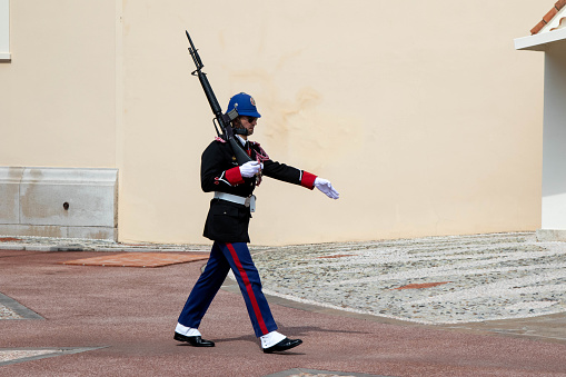 Monte-Ville, Monaco, April 21st 2023:- A member of the Compagnie des Carabiniers du Prince marching outside the Palace in Monaco
