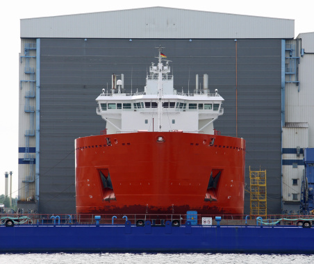 New Cargo ship in front of a shipyard hall in Rostock (Germany)