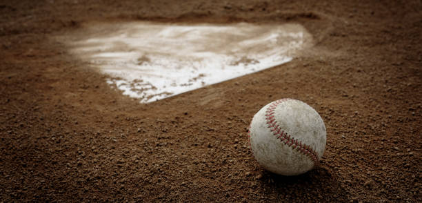 istock Old Leather Baseball on Field by Home Plate or Base 1485423555