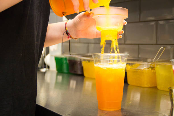 istock Pouring mixed tea from plastic jug to plastic shot, prepared for iced milk tea with bubble or boba. 1485423766