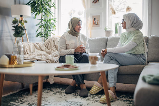 istock Women friends sitting on sofa 1485424314
