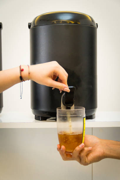 istock Pouring mixed tea from plastic jug to plastic shot, prepared for iced milk tea with bubble or boba. 1485424421