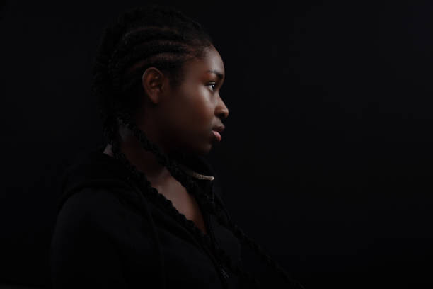 istock Cool and Real Black Female Model Looking Away Against Black Background 1485424944