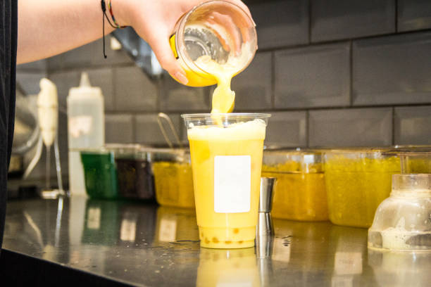 istock Pouring mixed tea from plastic jug to plastic shot, prepared for iced milk tea with bubble or boba. 1485426283