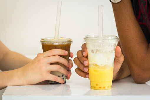 Cropped shot of  young couple holding a couple cup of iced Bubble tea
