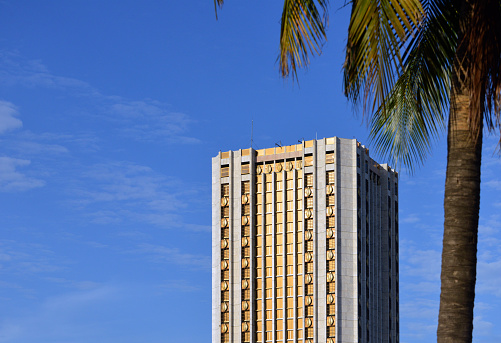 Cotonou, Benin: tower of the Central Bank of West African States / Banque Centrale des États de l'Afrique de l'Ouest, BCEAO - central bank serving the countries that share the West African CFA franc currency, comprising the West African Economic and Monetary Union (UEMOA). Golden façade with coffee beans on  - John Paul II Avenue. The tallest building in Benin.