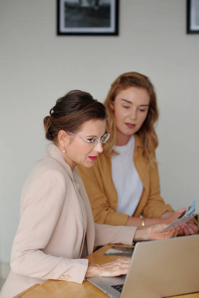 istock Two female workers of art gallery discussing online information 1485429649