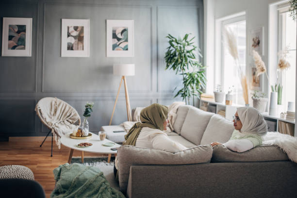 istock Women friends sitting on sofa 1485430536