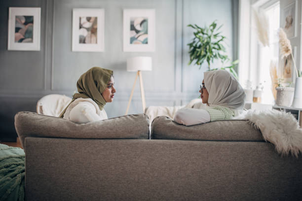 istock Women friends sitting on sofa 1485430963
