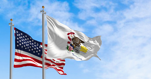 The Illinois state flag waving along with the national flag of the United States of America on a clear day. 3D illustration render. Fluttering fabric