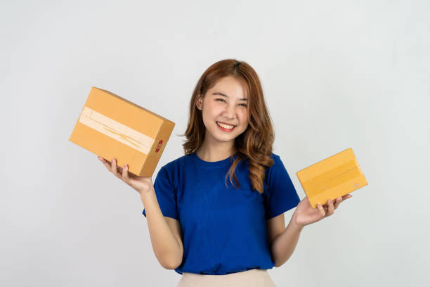 istock Happy asian woman holding parcel boxes doing various gestures isolated on white background Delivery and courier service concept 1485436242