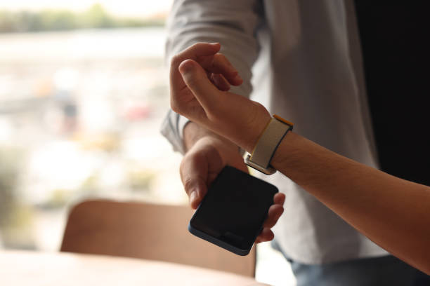 Man making NFC payment with his smart watch