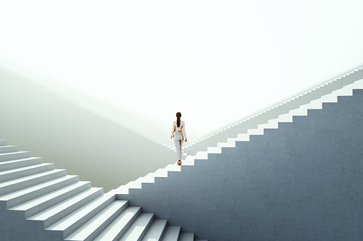 Businesswoman walking between endless abstract  stairs. 3D generated image.