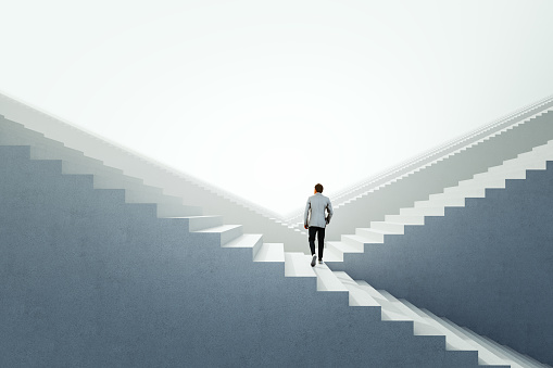 Businessman walking between endless abstract  stairs. 3D generated image.