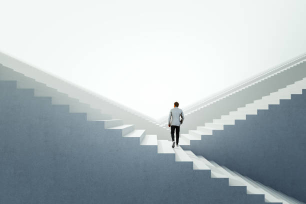 Businessman walking between endless abstract stairs Businessman walking between endless abstract stairs. 3D generated image. never ending photos stock pictures, royalty-free photos & images