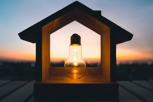 istock Light bulb with wood house on the table, a symbol for construction, Creative light bulb idea, power energy or business idea concept ecology, loan, mortgage, property or home. 1485440217
