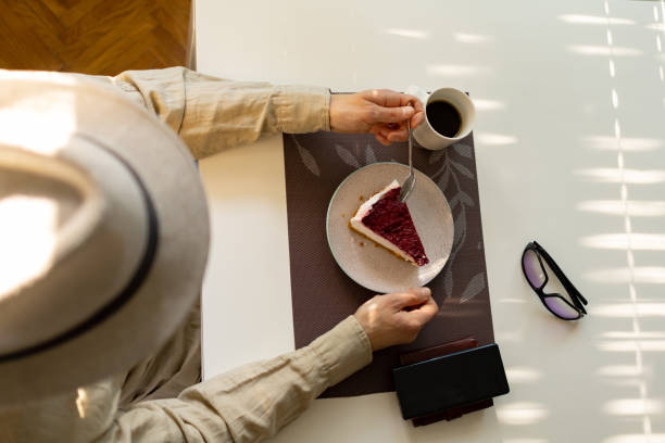 istock Man siting in caffe eating a slice of raspberry cheesecake 1485441681