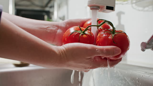 Close-up Washing Tomato vegetables in kitchen