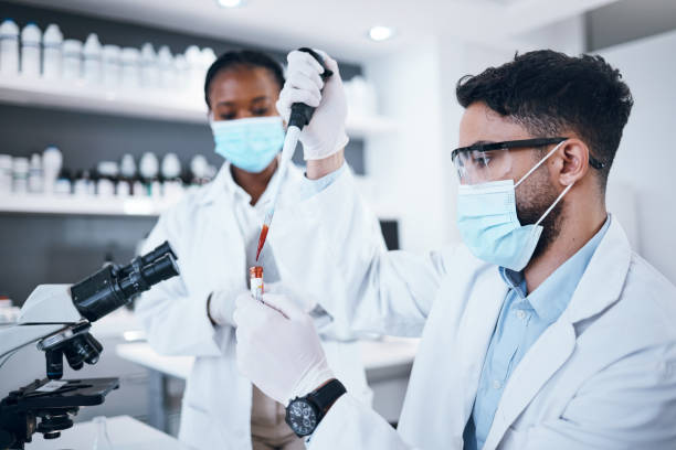 istock Science, blood and team with vial in laboratory for scientific research, dna testing or exam. Healthcare, medicine and scientists with pipette for liquid sample, rna results and medical analytics 1485442704