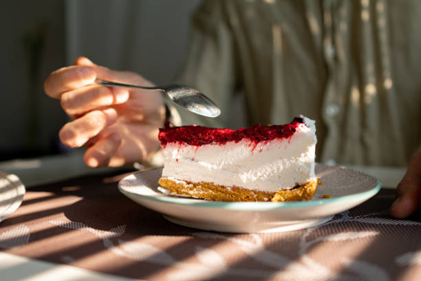 istock Man siting in caffe eating a slice of raspberry cheesecake 1485442809