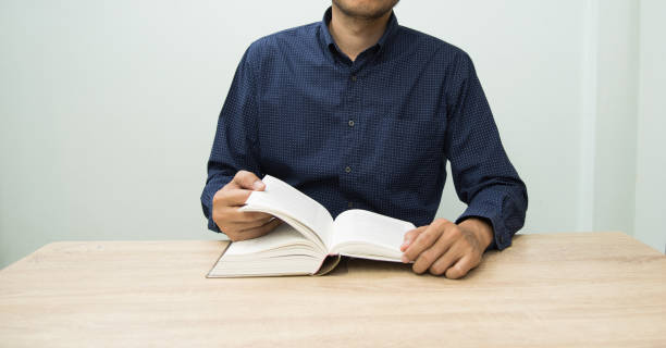 istock The man in deep blue shirt reading the book in library at university. 1485442848
