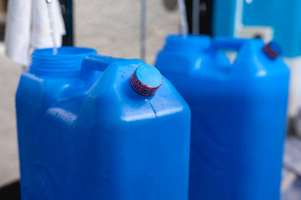 istock A blue 20 liter HPDE water container being refilled with purified H2O. The top cap already sealed with shrink wrap. 1485443281