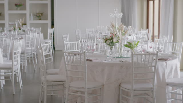 Tables, chairs and decoration in a wedding venue for a marriage ceremony, reception or celebration of love and tradition. Luxury, event and modern decor in an interior room of a function hall