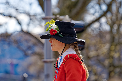 Spring Festival named Sechseläuten with female horse rider in historical dress at City of Zürich on a blue cloudy spring day. Photo taken April 17th, 2023, Zurich, Switzerland.