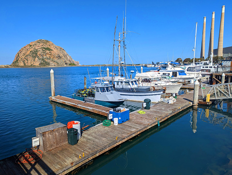 Morro Rock and fishing harbor docks in Morro  Bay California April 2023