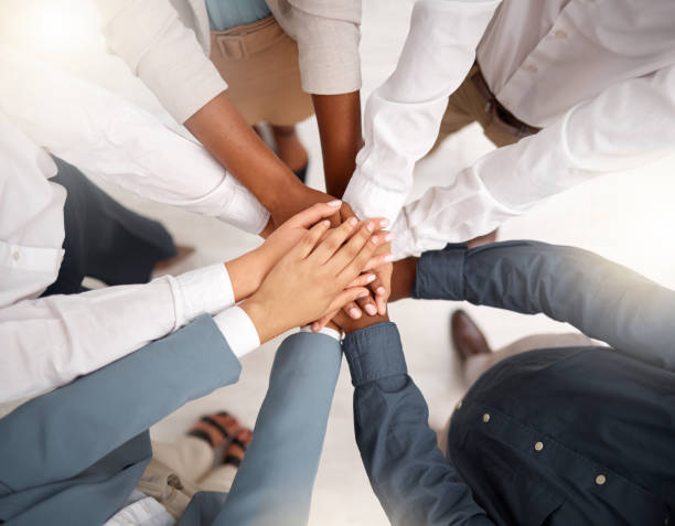 istock Team, diversity and stack of hands in the office for unity, celebration or support for solidarity. Collaboration, multiracial and top view of group of business people with motivation and in workplace 1485451608