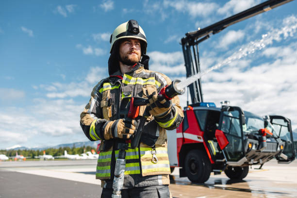 bearded firefighter in the action - water cannon imagens e fotografias de stock