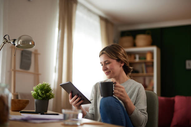 istock Women using digital tablet to check her finances at home office 1485456768