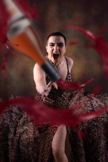 Displeased Party woman throwing bottle in anger. Displeased Party woman throwing bottle in anger. Mad sexy young woman in isolated background screams annoyed. Loud noise, furious angry millennial Indian girl yell shout bothered by noisy disturbing sound. vex nightclub stock pictures, royalty-free photos & images