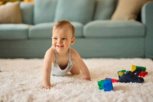 Portrait of a cute crawling baby boy at home