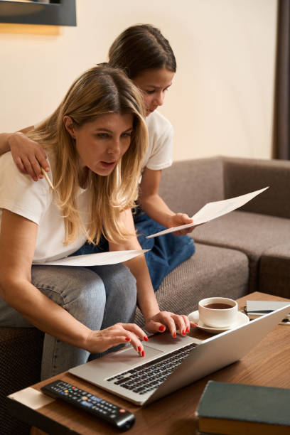 istock Little daughter helping her mother working at home 1485459666