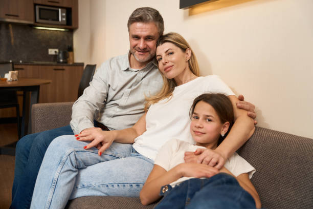 istock Young family sitting on couch in kitchen 1485459703