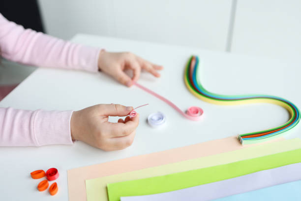 istock Children's activities, hands with paper top view, quilling technology 1485461882
